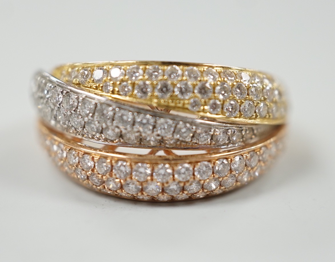 A modern three colour 18ct gold and diamond chip cluster set three row crossover ring, size O, gross weight 6.9 grams.